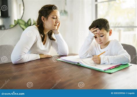 Mother Teaching Bored Son and Helping with Homework at Home Stock Photo ...
