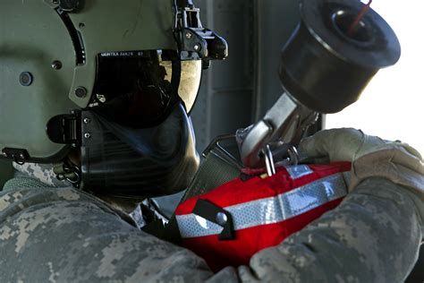 Army Sgt. Nathan McLaughlin flies in a UH-60 Black Hawk helicopter as ...