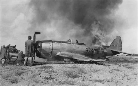 Damage crews dousing the flames after a P-47N Thunderbolt of the 413th ...