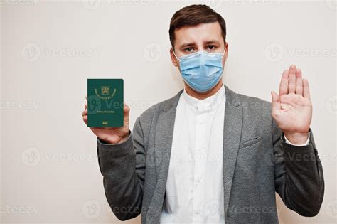 European man in formal wear and face mask, show Vatican City passport ...