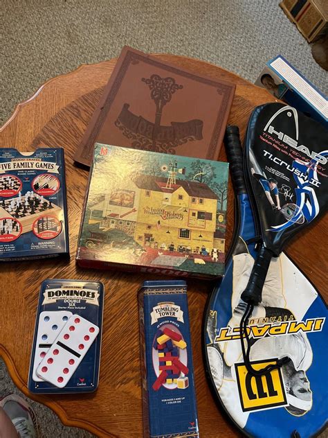 Two tennis rackets with a collection of games and vintage puzzle and a ...