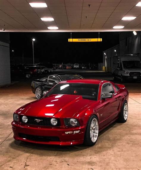 Red Mustang parked in a garage