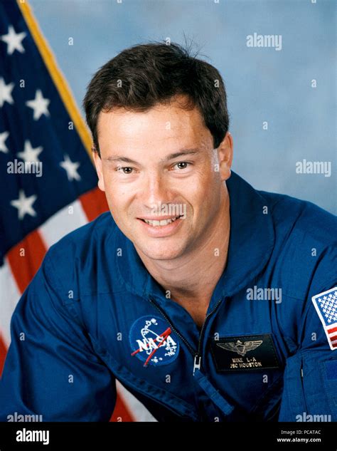 Official Portrait of Astronaut Candidate (ASCAN) Michael Lopez Alegria in blue flight suit with ...