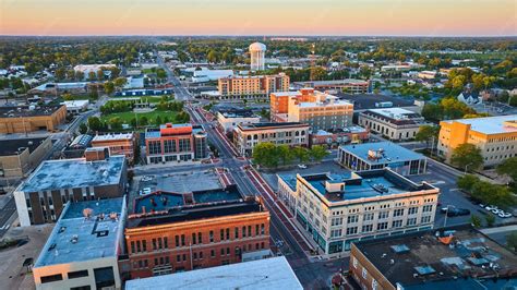 Premium Photo | Downtown muncie indiana aerial at dawn with yellow sunrise lighting on buildings ...
