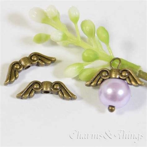 C&T 天使の羽 C メタルビーズ 約16x5mm 穴約1.5mm ウィング (22個入) アクセサリーパーツ Wing ビーズ スペーサー ...