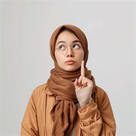 Asian muslim woman pointing finger pose hijab advertising photography ...