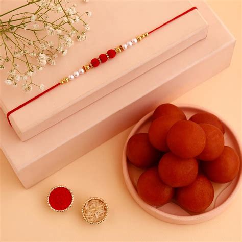 Send White Pearl And Velvet Beads Rakhi with 1 Kg Gulab Jamun Online ...