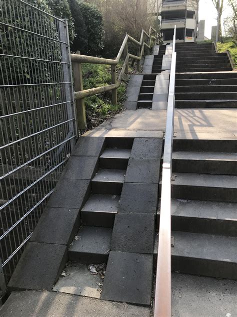 Wheelchair-Friendly Stairwell with Ramp and Metal Railings