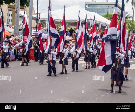 Young people marching holding the Costa Rican flag in the Independence ...