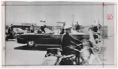 [John F. Kennedy's foot extending over side of presidential limousine ...