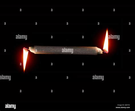 BURNING CANDLE AT BOTH ENDS Stock Photo - Alamy