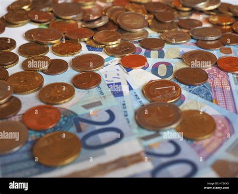 Euro (EUR) banknotes and coins, currency of European Union (EU) useful as a background Stock ...