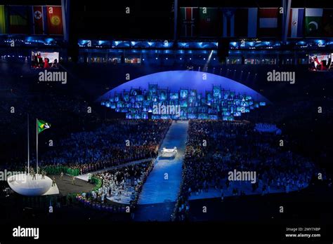 The Olympic flag is carried in during the opening ceremony for the 2016 ...