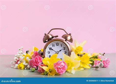 Alarm Clock with Spring Flowers. Spring Time, Daylight Savings Concept ...