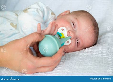 Mother Using Bulb Syringe To Clean Baby S Nose Stock Image - Image of ...