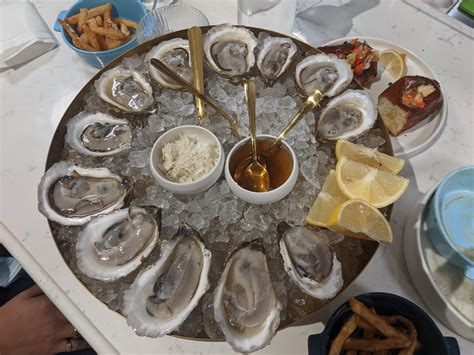 [I ate] a dozen Beau Soleil oysters, served with lemon, horseradish ...