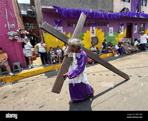 On Holy Friday in Iztapalapa, faithful people carry large wooden ...