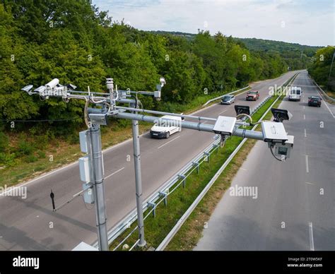 Cameras and speed control radars along a busy highway monitor and record speeding violations ...