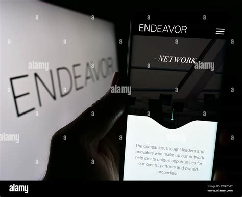 Person holding cellphone with website of US talent agency company ...