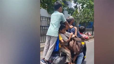 Travelling on scooter with seven children without wearing helmet; youth ...