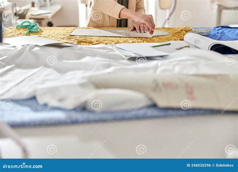 Lady Dressmaker Draws Pattern on Yellow Fabric at Large Cutting Table ...