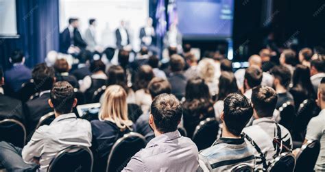 Speaker giving a talk in conference hall at business event rear view of ...