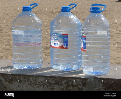 Large 5 litre drinking water containers on wall next to beach Stock ...