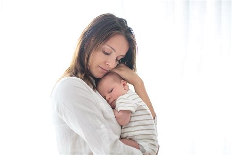 Young mother, holding her newborn baby boy - MGH Center for Women