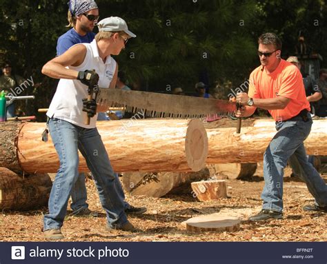 Man and woman using two man crosscut saw in Jack and Jill lumberjack ...