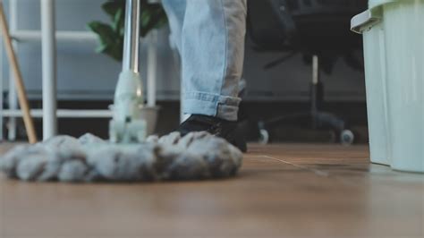 Housewife using vacuum cleaner on the floor. Wearing an apron to clean ...