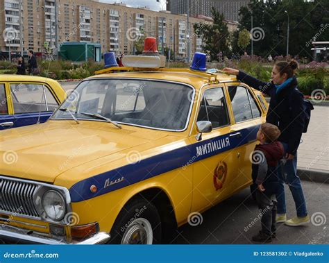 People at the Soviet Police Car GAZ-24 `Volga` at the Exhibition of Old Equipment. Editorial ...