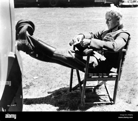 MARLON BRANDO relaxing on set candid reading a book during a break in ...