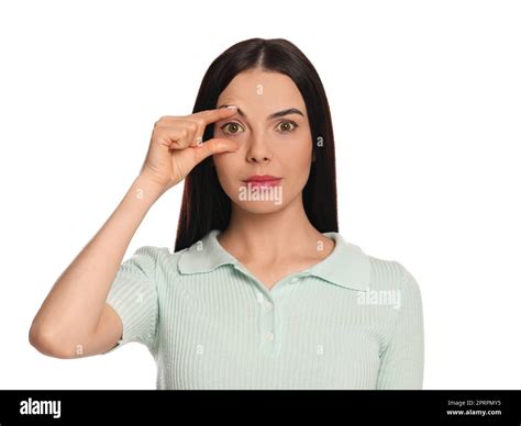 Woman checking her health condition on white background. Yellow eyes as symptom of problems with ...