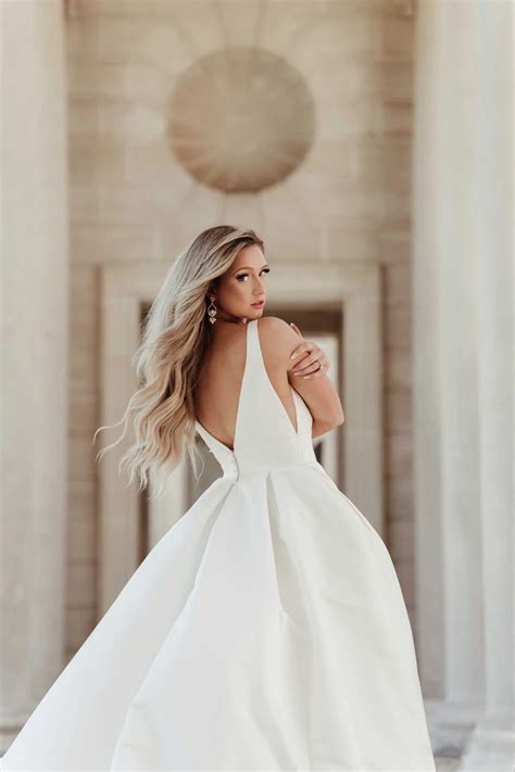 7755 | Stella York | Modern Luxe Ballgown Wedding Dress with Deep V-Neckline | Essense Designs