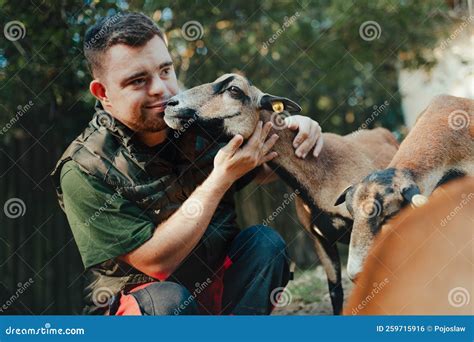 Caretaker with Down Syndrome Taking Care of Animals in Zoo, Stroking ...