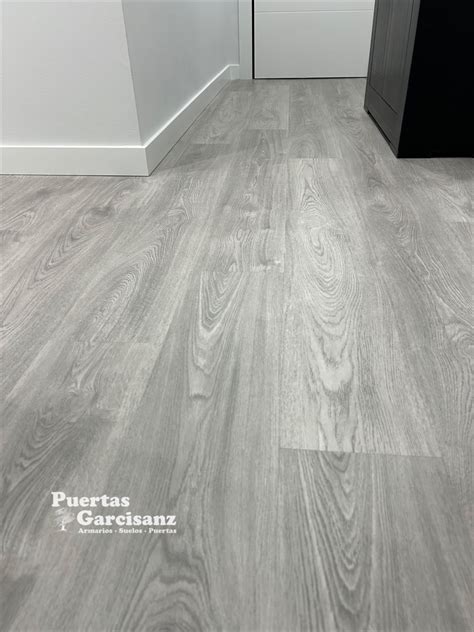 Grey Wood Laminate Flooring with White Skirting Board