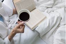 leggere a letto soft photo of on the bed with book and cup of leggere a letto soft photo of on the bed with book and cup of