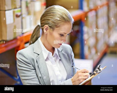 Getting to grips with the numbers. a woman doing an inventory check in a warehouse Stock Photo ...
