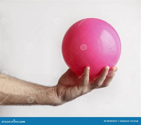 Man`s hand holding a ball stock photo. Image of kilogram - 86402422