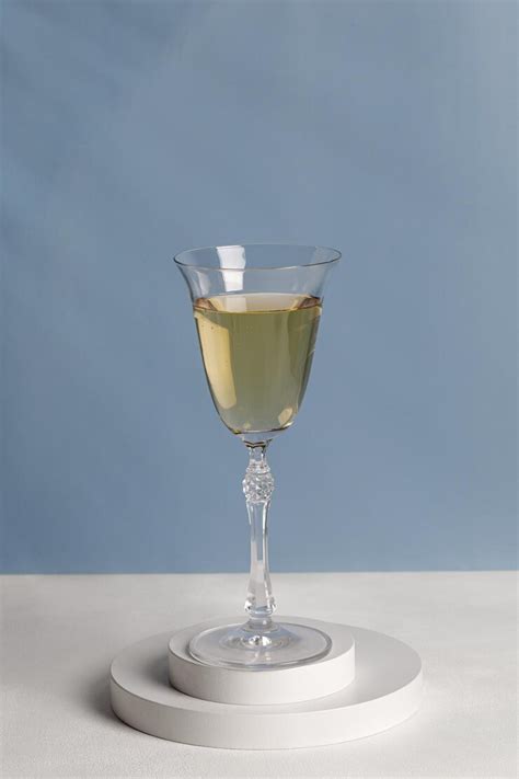 Wine in glass on white podiums. glass of wine on pedestal in sunlight ...