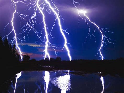 Download A bolt of lightning streaks across the night sky. | Wallpapers.com