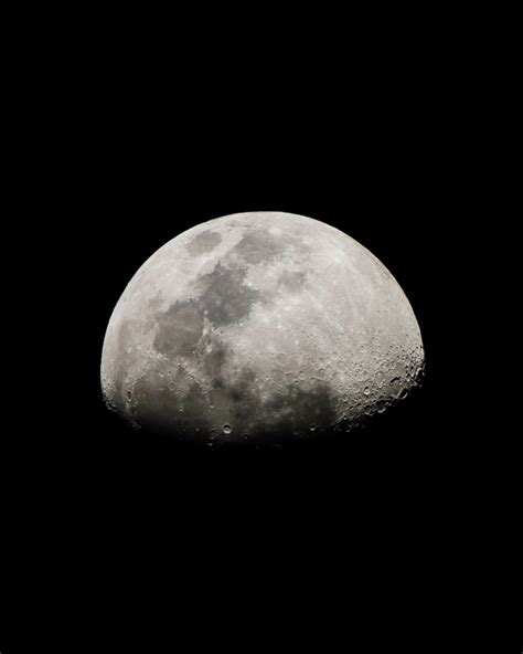 a gibbous moon with a dark sky background