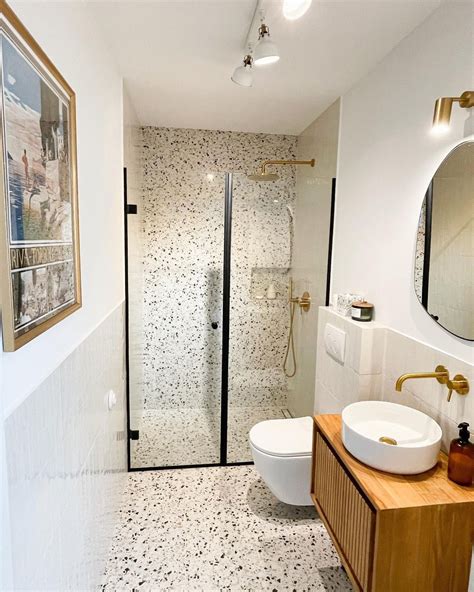 Terrazzo Flooring and Brass Accents for a Luxurious Bathroom Design