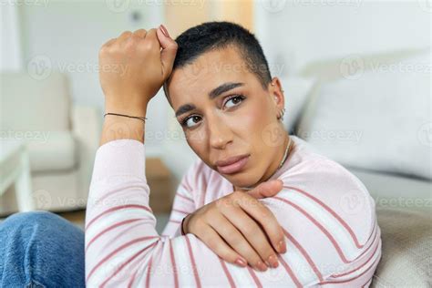 Unhappy african American woman on sofa crying. Lonely sad woman deep in thoughts sitting ...
