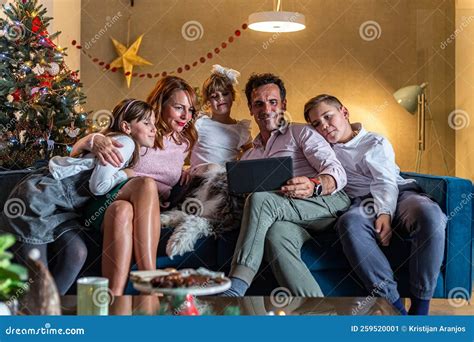 A Happy Family is Sitting on the Couch in Living Room and Having a ...