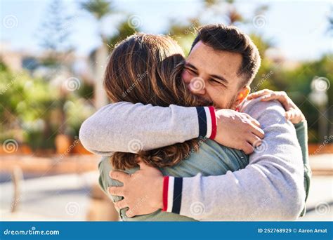 Man and Woman Smiling Confident Hugging Each Other Standing at Park ...