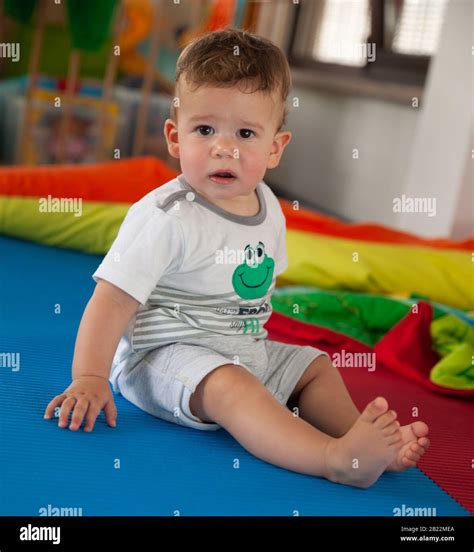 Little baby boy playing in living room on the floor Stock Photo - Alamy