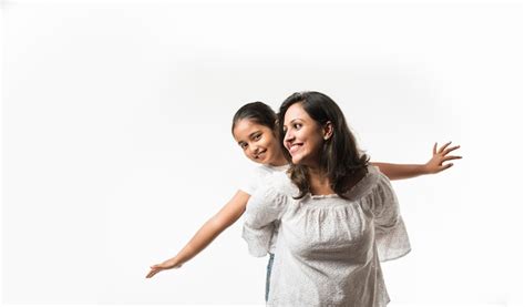 Indian mother daughter on white background hugging, kissing, riding ...