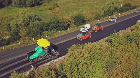 Aerial view. Laying a new asphalt on the road. Construction of the road ...