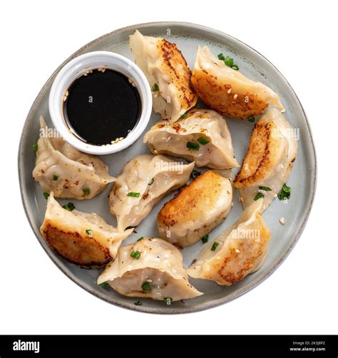 Taiwanese and Japanese Pan-fried gyoza dumpling jiaozi food in a plate ...
